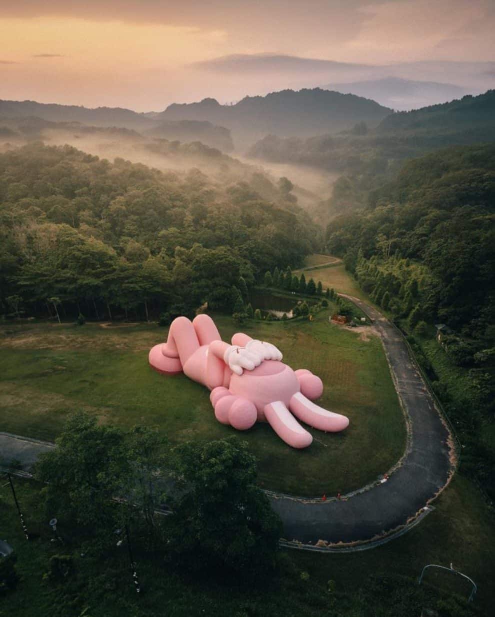 KAWS Unveils Colossal 150ft Pink Rabbit Sculpture Indonesian Temple