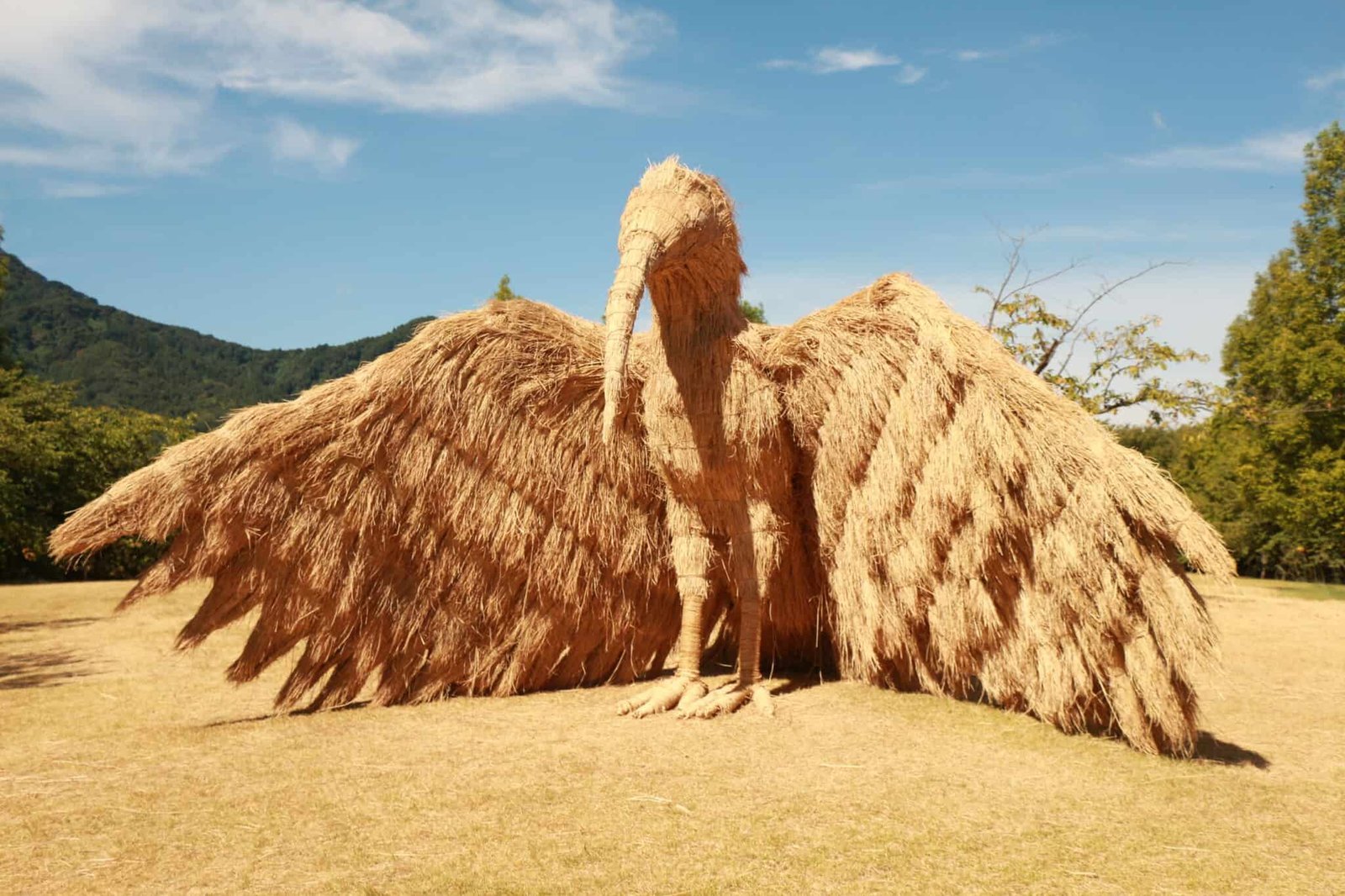 a mammoth bird sculpture made of straw