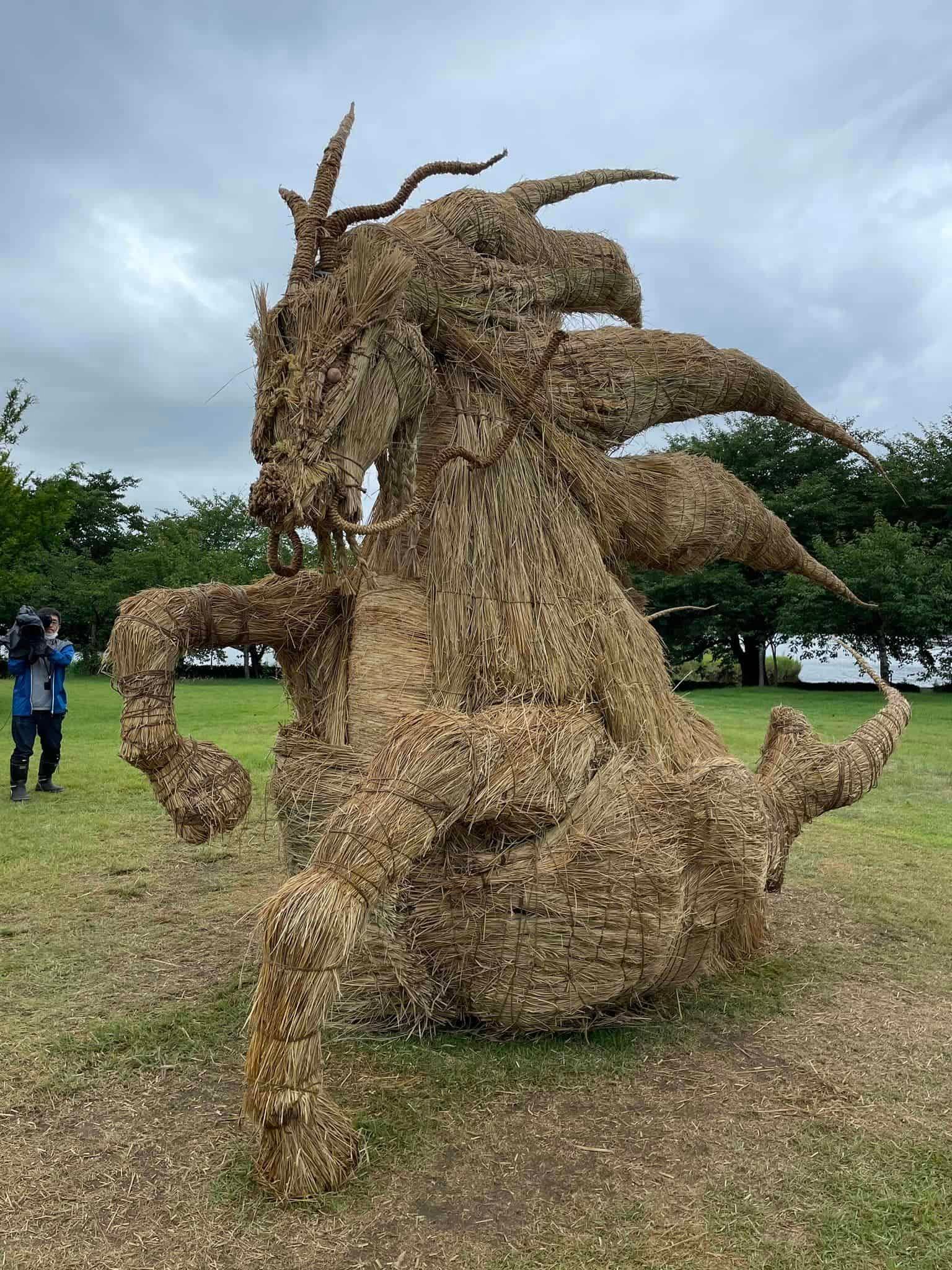 a mammoth dragon sculpture made of straw