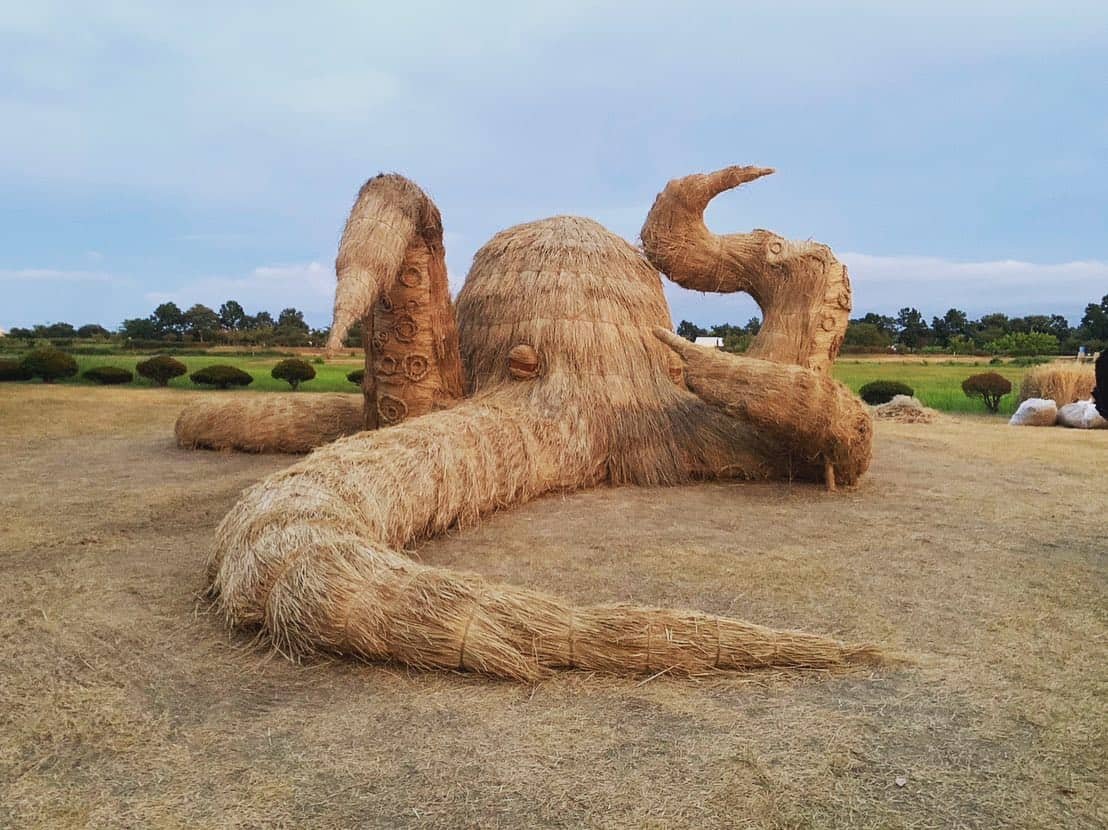 a mammoth octopus sculpture made of straw